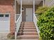 Inviting home entrance with brick steps, white railings, and a charming front door at 5945 Four Townes Ln, Raleigh, NC 27616