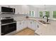 Beautiful kitchen featuring stainless steel appliances, granite counters, and ample cabinet space at 5945 Four Townes Ln, Raleigh, NC 27616