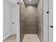 Modern shower with floor-to-ceiling tiling and sleek hardware at 5945 Four Townes Ln, Raleigh, NC 27616
