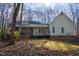 Spacious backyard featuring a green lawn, mature trees, and a screened porch area at 613 Hamecon Place, Cedar Grove, NC 27231
