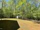 Large backyard with mature trees and a shed for additional storage or hobbies at 613 Hamecon Place, Cedar Grove, NC 27231