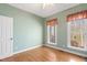 Light-filled bedroom with wood floors and views of wooded area at 613 Hamecon Place, Cedar Grove, NC 27231
