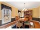 Dining room showcasing a wooden table set, china cabinet, large window, and natural light at 613 Hamecon Place, Cedar Grove, NC 27231