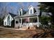 Charming house with a covered porch and front yard featuring an American flag at 613 Hamecon Place, Cedar Grove, NC 27231