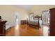 Bright main bedroom with wood floors, en-suite bathroom, and large windows overlooking wooded area at 613 Hamecon Place, Cedar Grove, NC 27231