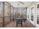 Inviting screened porch with dining set, ceiling fan, and lattice railing at 613 Hamecon Place, Cedar Grove, NC 27231