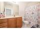 Bright bathroom features a wooden vanity, large mirror, and a shower with seashell-patterned curtain at 622 Ives Ct # 622, Chapel Hill, NC 27514