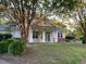 Charming clubhouse with white pillars, well-manicured lawn, and surrounding greenery at 622 Ives Ct # 622, Chapel Hill, NC 27514