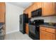 Well-appointed kitchen featuring wooden cabinets, black appliances, and tiled flooring at 622 Ives Ct # 622, Chapel Hill, NC 27514
