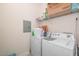 Convenient laundry area with side-by-side washer and dryer and an overhead storage shelf at 622 Ives Ct # 622, Chapel Hill, NC 27514