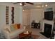 Comfortable living room featuring neutral walls, ceiling fan, fireplace, and access to hallway doors at 622 Ives Ct # 622, Chapel Hill, NC 27514