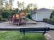 Community playground with a slide, climbing structure, and a bench for parents at 622 Ives Ct # 622, Chapel Hill, NC 27514