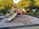 Neighborhood playground with a slide and climbing structure in a secure, mulched area at 622 Ives Ct # 622, Chapel Hill, NC 27514