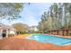 Community pool surrounded by mature trees and a pergola, perfect for relaxation at 622 Ives Ct # 622, Chapel Hill, NC 27514
