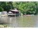 Charming lake house with water access, including boat slips and colorful paddle boats for rent at 622 Village Lake Drive, Mebane, NC 27302