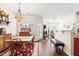 Open dining area with wood floors, chandelier, vintage furniture, and seamless transition to living room at 622 Village Lake Drive, Mebane, NC 27302