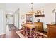 Inviting dining room with classic decor, wood floors, decorative lighting, and access to multiple rooms at 622 Village Lake Drive, Mebane, NC 27302