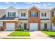 Charming townhouse with brick and siding exterior, well-maintained lawn, and attached garage on a sunny day at 622 Village Lake Drive, Mebane, NC 27302