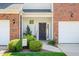 Inviting front entrance with a decorative wreath on a black door, landscaping, and a 'Welcome' sign at 622 Village Lake Drive, Mebane, NC 27302