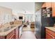 Open kitchen featuring wood cabinets, granite countertops, stainless steel appliances, and view into the living room at 622 Village Lake Drive, Mebane, NC 27302