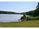 Picturesque lake view with a bench by the water's edge, offering peaceful relaxation at 622 Village Lake Drive, Mebane, NC 27302