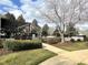 Community pool area with a pergola and lounge chairs, surrounded by lush greenery and trees at 622 Village Lake Drive, Mebane, NC 27302