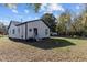 Backyard view of home with lawn and trees at 703 Vance St, Henderson, NC 27536