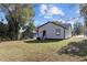 Backyard view of home with lawn and trees at 703 Vance St, Henderson, NC 27536