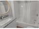 This bathroom features a granite countertop and a shower-tub combo at 703 Vance St, Henderson, NC 27536