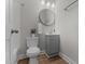 Bathroom featuring toilet, sink, vanity, mirror and lighting at 703 Vance St, Henderson, NC 27536
