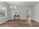 Bright dining room with modern chandelier, table, and ample natural light at 703 Vance St, Henderson, NC 27536
