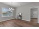 Dining area with a modern chandelier, and natural light from large windows at 703 Vance St, Henderson, NC 27536