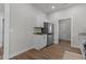 Modern kitchen with stainless steel appliances, white cabinets, and a granite countertop at 703 Vance St, Henderson, NC 27536