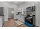 Modern kitchen featuring white cabinets, granite countertops, and stainless steel appliances at 703 Vance St, Henderson, NC 27536