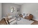 Bright living room featuring a comfortable brown sofa, stylish decor, and hardwood floors at 703 Vance St, Henderson, NC 27536