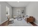 Open living room with leather sofa, modern chairs, and natural light at 703 Vance St, Henderson, NC 27536