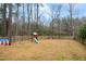A level back yard has dormant grass, playground equipment and privacy fencing at 7100 Winter Pond Way, Fuquay Varina, NC 27526
