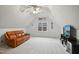 Bonus room with carpet, ceiling fan, and a large brown leather couch at 7100 Winter Pond Way, Fuquay Varina, NC 27526