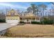 Lovely two-story yellow home with a welcoming porch and landscaped yard, featuring a two-car garage at 7100 Winter Pond Way, Fuquay Varina, NC 27526