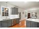 Modern kitchen with stainless steel appliances, hardwood floors, and gray cabinets at 7100 Winter Pond Way, Fuquay Varina, NC 27526