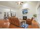 Bright living room featuring a fireplace, high ceilings, hardwood floors, and comfortable leather seating at 7100 Winter Pond Way, Fuquay Varina, NC 27526