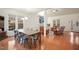 Open floor plan featuring a dining room and living room, hardwood floors, and bright natural light at 7100 Winter Pond Way, Fuquay Varina, NC 27526