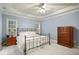 Bedroom with a ceiling fan, carpeted floors, and natural light at 7100 Winter Pond Way, Fuquay Varina, NC 27526