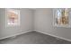 Bedroom with soft carpet and natural light from the windows at 838 Waring St, Durham, NC 27704