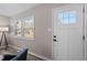 Well lit entryway with a view from the windows and a white door at 838 Waring St, Durham, NC 27704