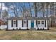 Charming renovated one-story home with a bright blue front door and black window shutters at 838 Waring St, Durham, NC 27704