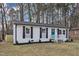 Attractive painted brick home with modern shutters and a well manicured front yard at 838 Waring St, Durham, NC 27704