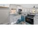 Updated eat-in kitchen featuring stainless steel appliances and modern countertops and backsplash at 838 Waring St, Durham, NC 27704