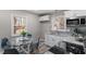 Renovated eat-in kitchen with white cabinetry, granite countertops, and stainless steel appliances at 838 Waring St, Durham, NC 27704