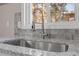 Modern sink and faucet with stainless steel appliances, granite countertops and gray backsplash at 838 Waring St, Durham, NC 27704